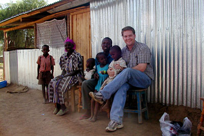 news-imageChris Barrett with farming family in Kenya